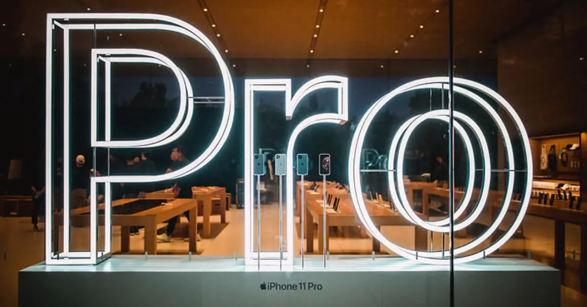 neon-pro-sign-display-inside-a-store-with-visible-smartphones-and-tables-in-the-background