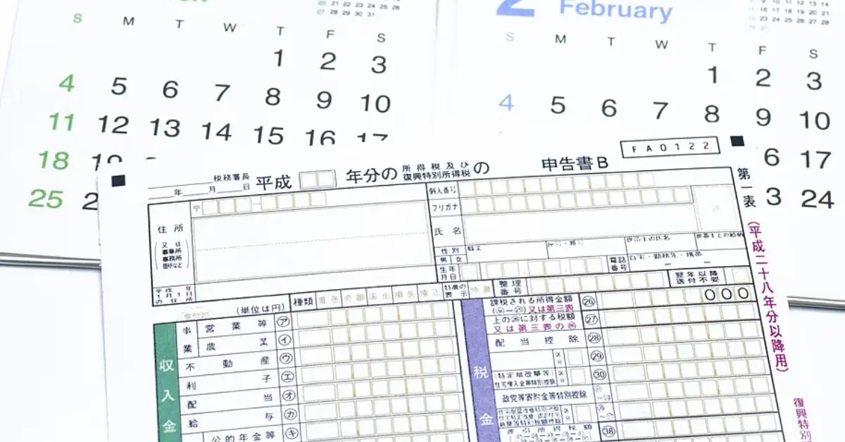 -close-up-of-a-tax-form-in-Japanese-beside-a-calendar-for-February-and-March-2018-highlighting-month-transitions